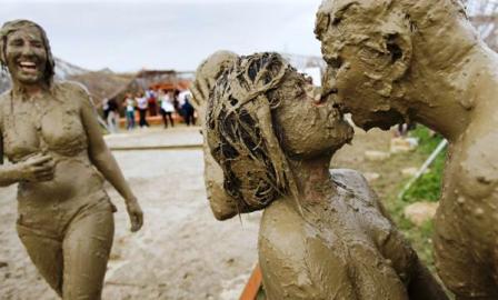 Festival visitors kiss after enjoying a mud bath during the 34th Paleo Festival, in Nyon, Switzerland.